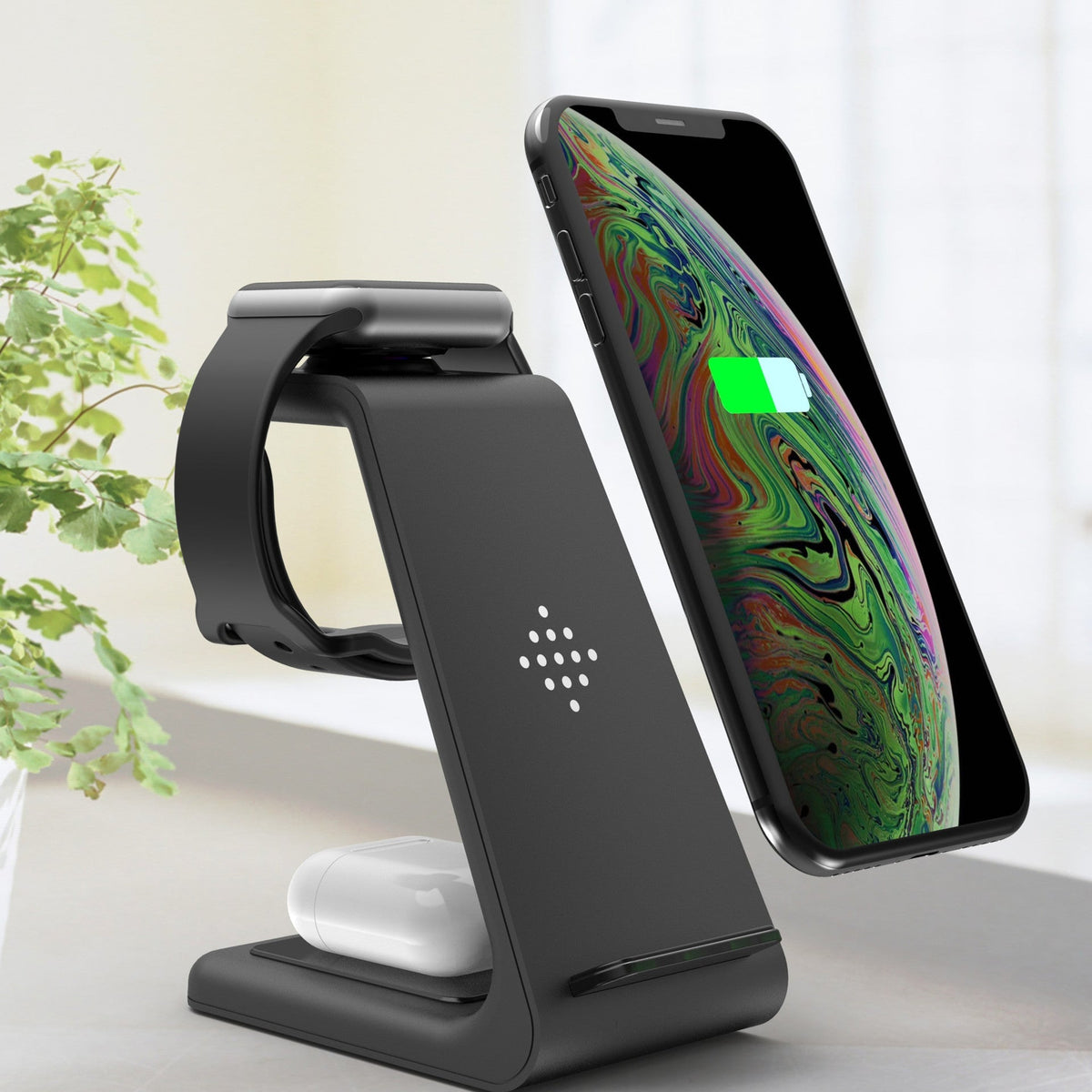 Phone, watch, and earbuds charging on a 3-in-1 wireless charging stand on a desk - Power Charging & Energy Solutions