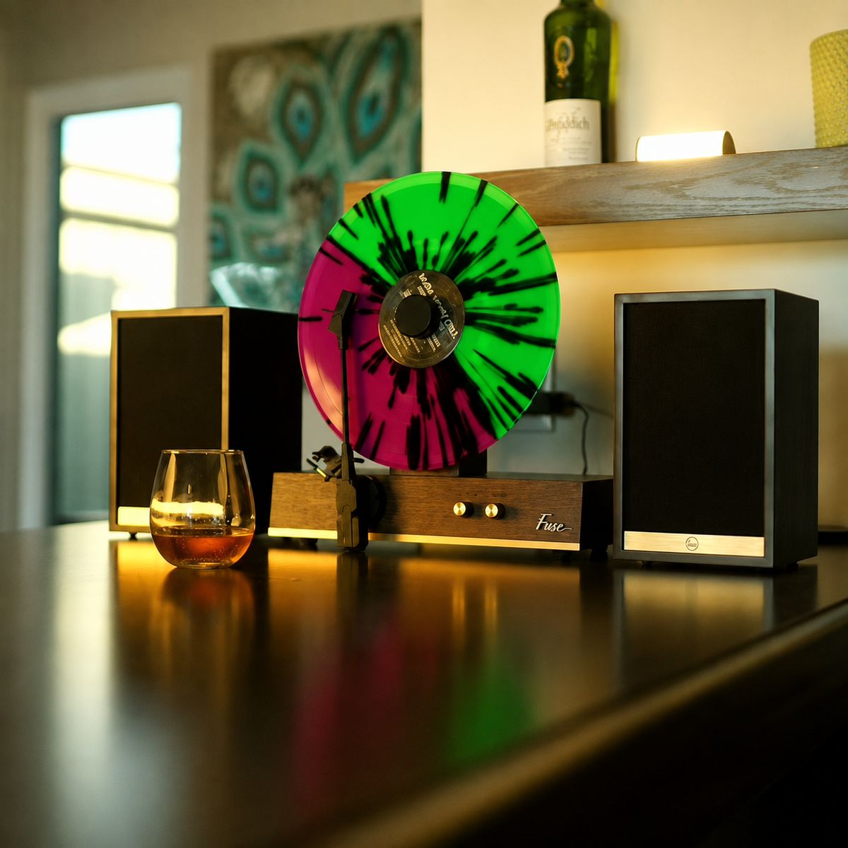 Vertical vinyl record player with green and pink splatter record playing, flanked by bookshelf speakers on a dark wood credenza - All Products